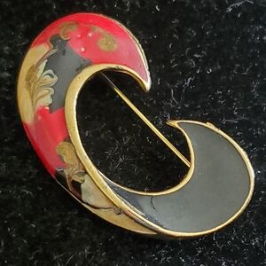 Vintage 1980s goldtone swirl brooch with black, red paint swirl design